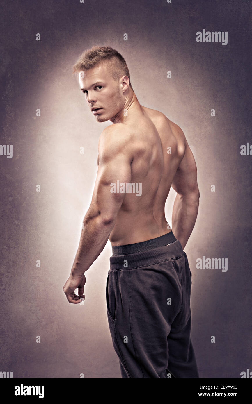 studio portrait of a young man in the bodybuilder pose Stock Photo