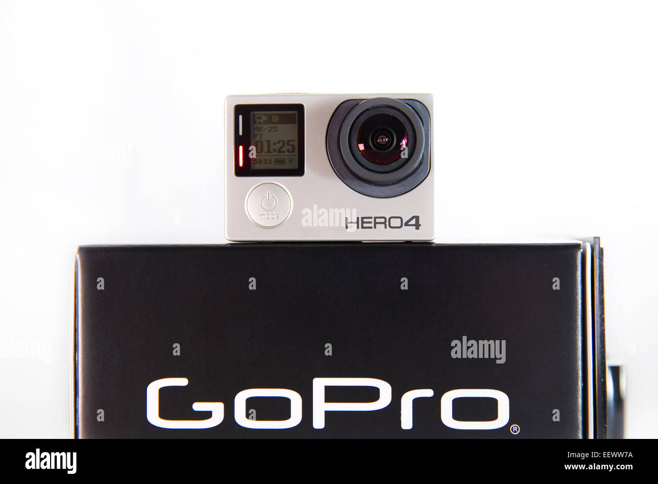 A GoPro Hero 4 Black edition is pictured in a studio on a white background. Stock Photo