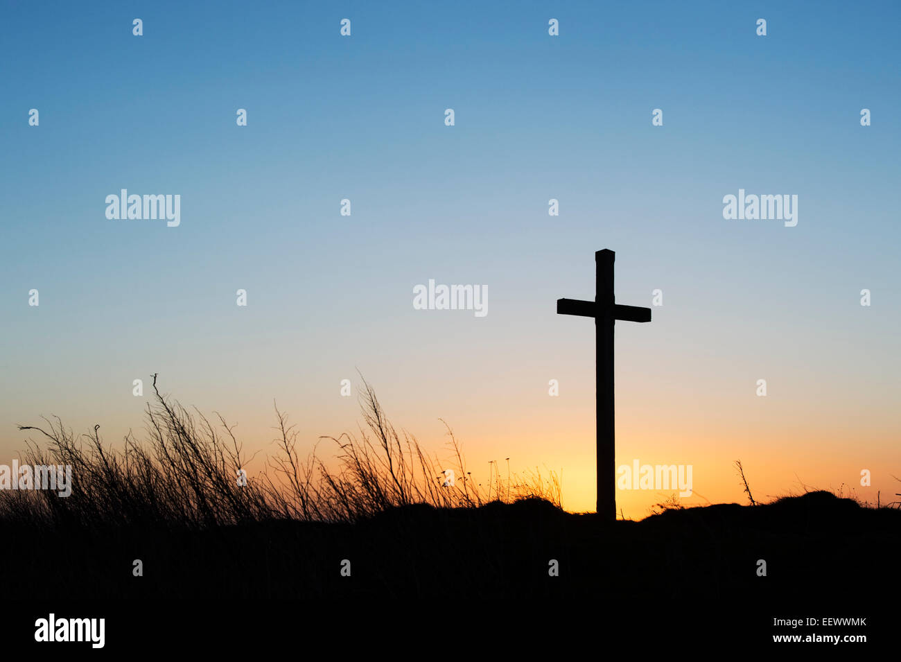St Cuthbert's Isle wooden cross on Holy Island, Lindisfarne at sunrise. Northumberland, England. Silhouette Stock Photo
