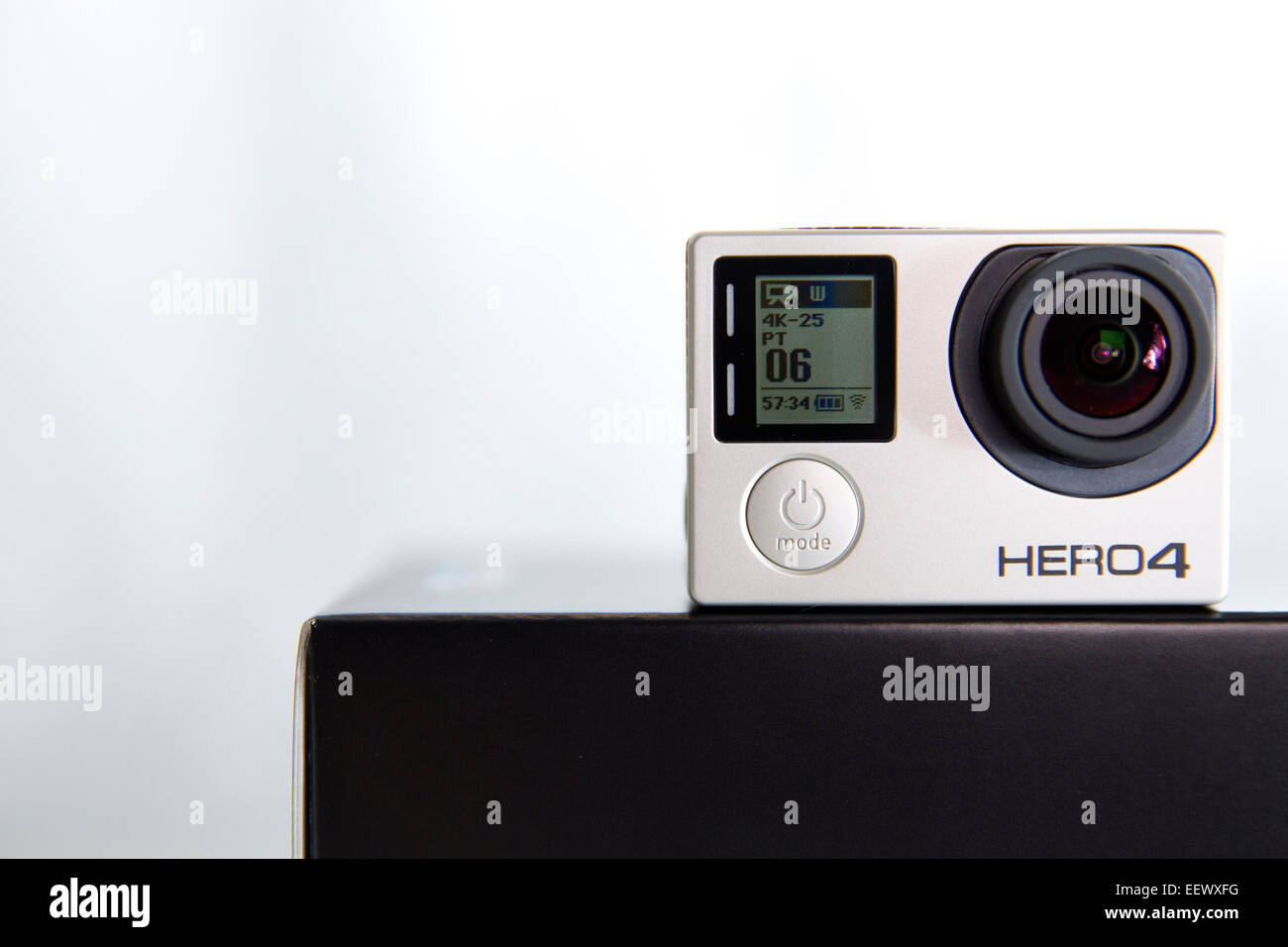A GoPro Hero 4 Black edition is pictured in a studio on a white background. Stock Photo