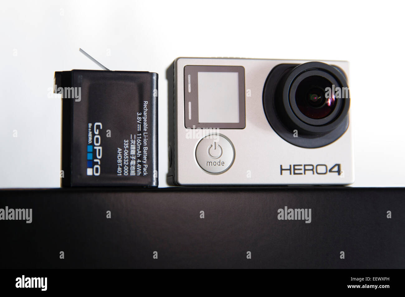 A GoPro Hero 4 Black edition is pictured in a studio with a battery on a  white background Stock Photo - Alamy