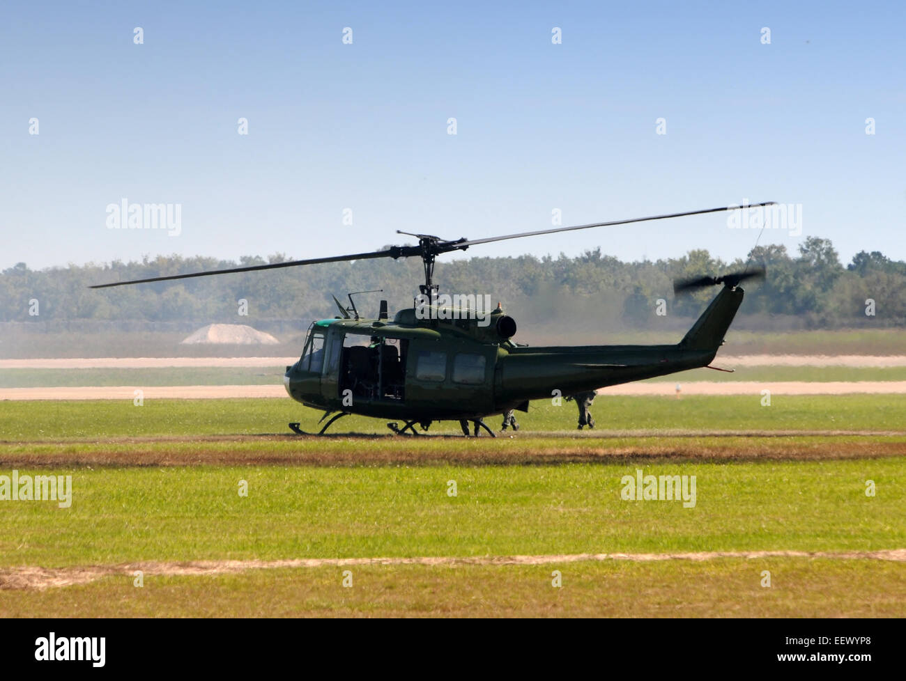 Old military helicopter landing in a field Stock Photo Alamy