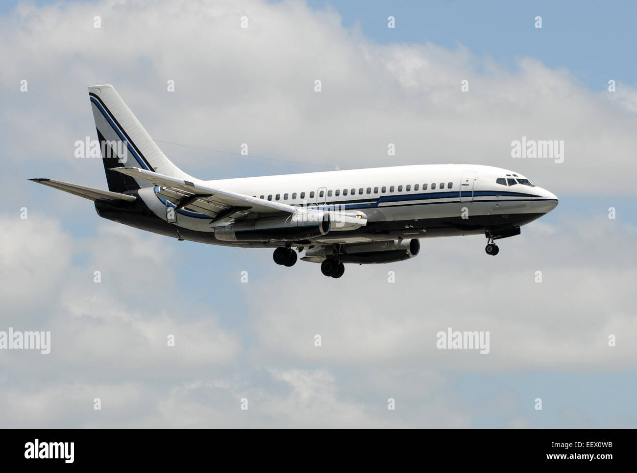 Old passenger jet airplane approaching for landing Boeing 737-200 Stock Photo