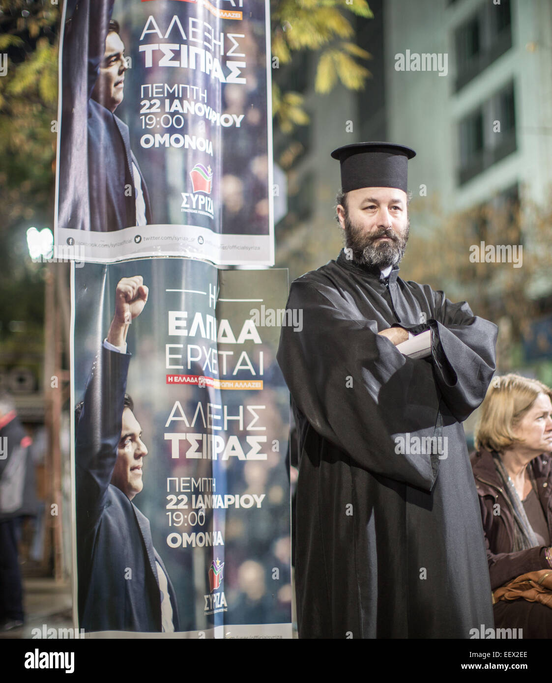 A priest is pictured next to poster of Alexis Tsipras, leader of the radical left main opposition party SYRIZA in Athens, 22 January prior to the last preelection rally. Greece's leftist, anti-austerity Syriza party has widened its lead at the top for the 25 January 2015 elections. Michael Kappeler/dpa (zu dpa 'Vor griechischer Schicksalswahl Linkspartei deutlich vorn' am 22.01.2015) Stock Photo