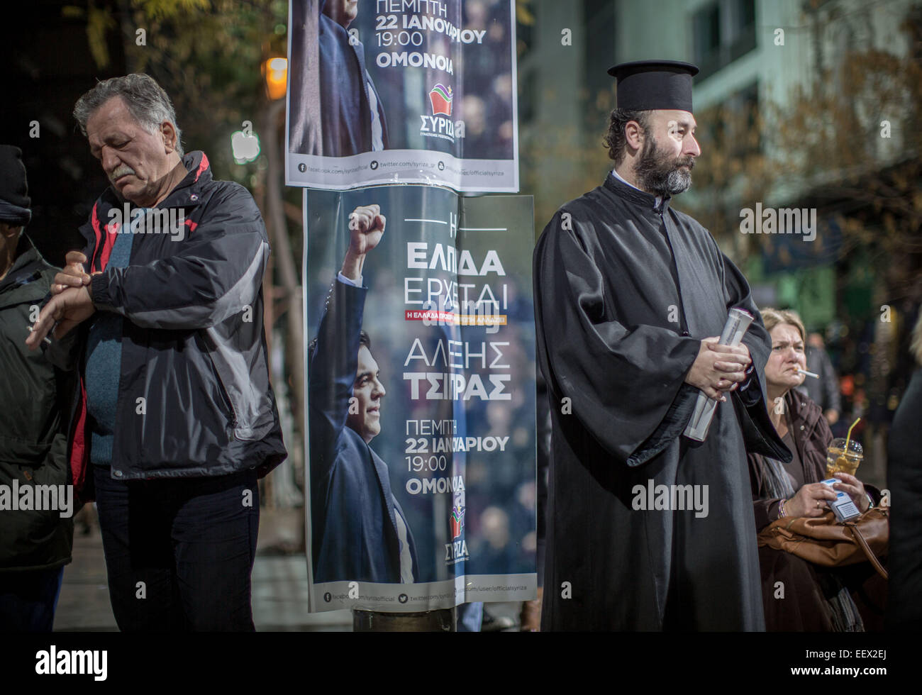 A priest is pictured next to a poster of Alexis Tsipras, leader of the radical left main opposition party SYRIZA in Athens, 22 January prior to the last preelection rally. Greece's leftist, anti-austerity Syriza party has widened its lead at the top for the 25 January 2015 elections. Michael Kappeler/dpa (zu dpa 'Vor griechischer Schicksalswahl Linkspartei deutlich vorn' am 22.01.2015) Stock Photo