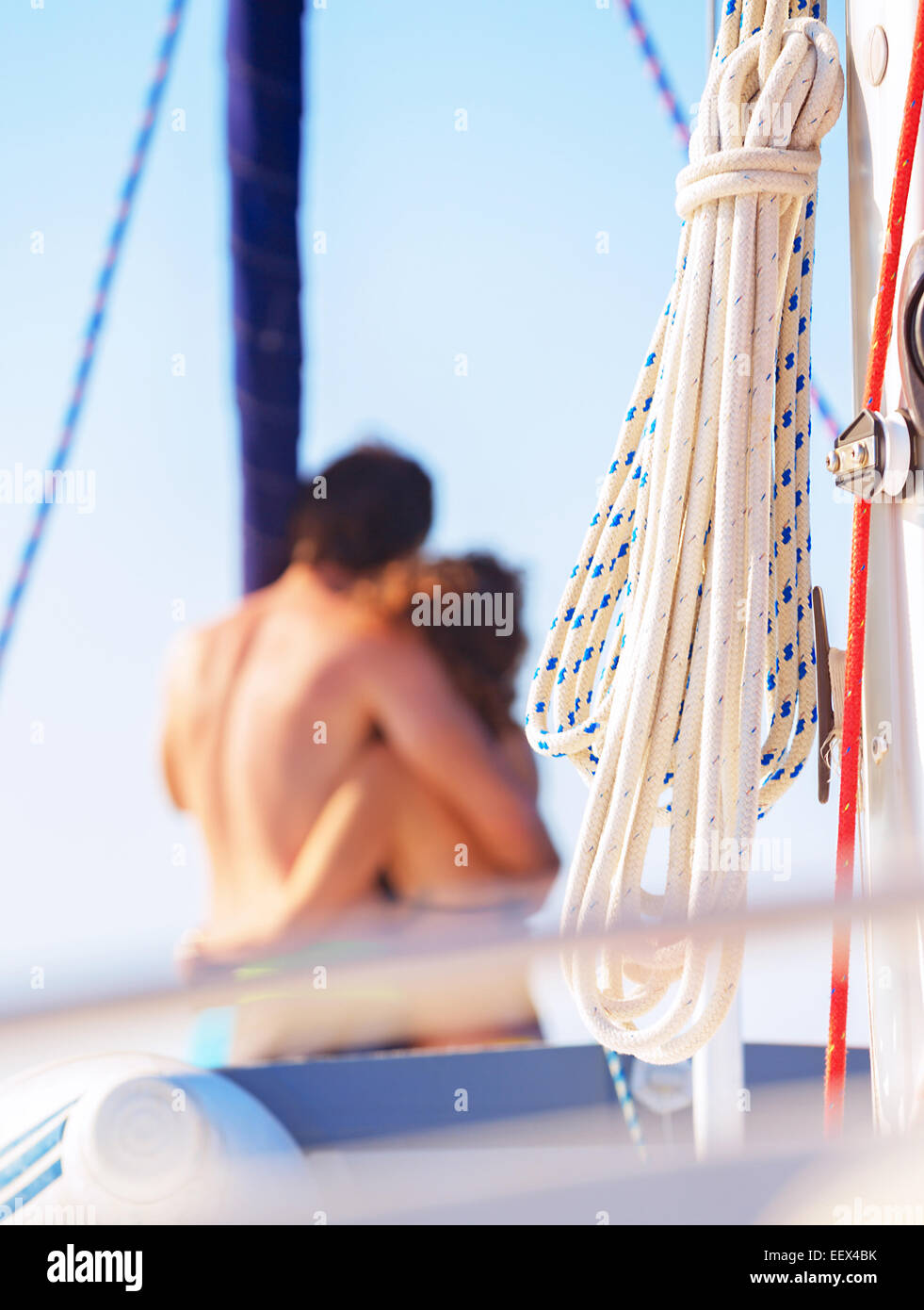 Selective focus on a  happy loving couple standing on the mast of yacht and hugging, romantic relationship, summer vacation Stock Photo