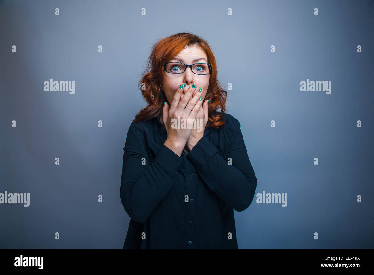 European - looking  woman years  hands over his mouth Stock Photo