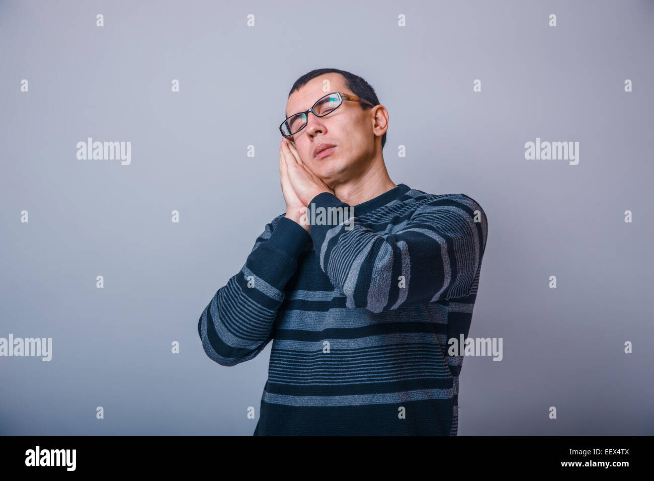 European-looking man years  in glasses  wants to sleep Stock Photo