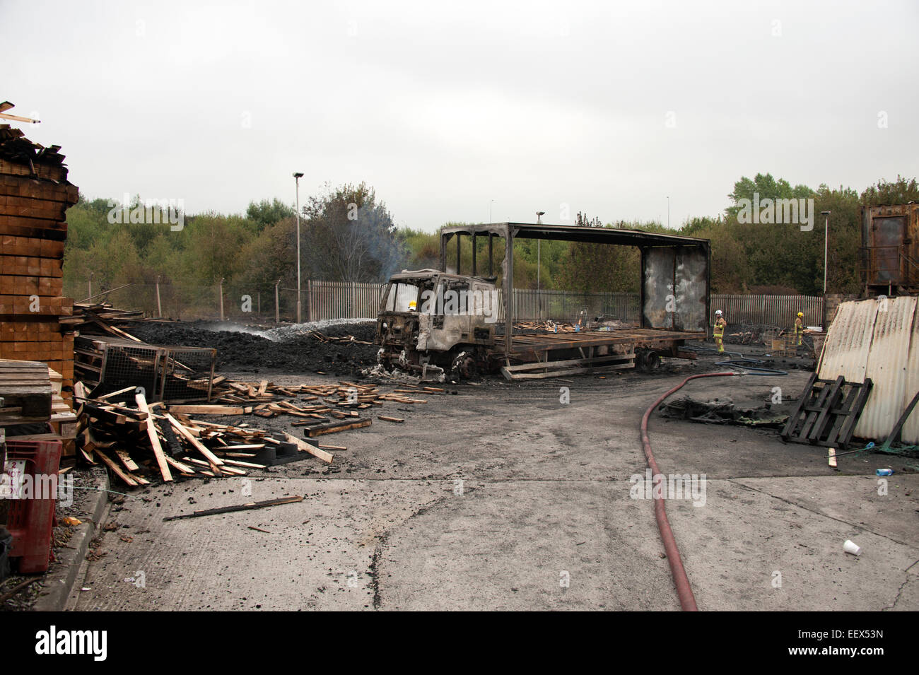 pallet yard fire lorry burnt out shell debris arson Stock Photo Alamy