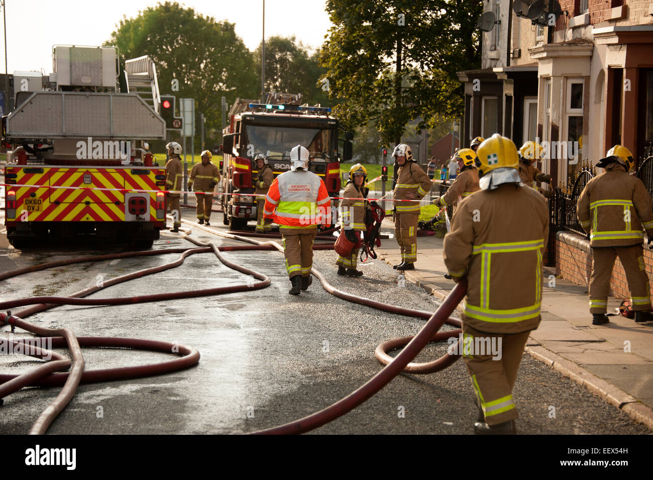 Lots of firemen hose firefighters big fire busy UK Stock Photo