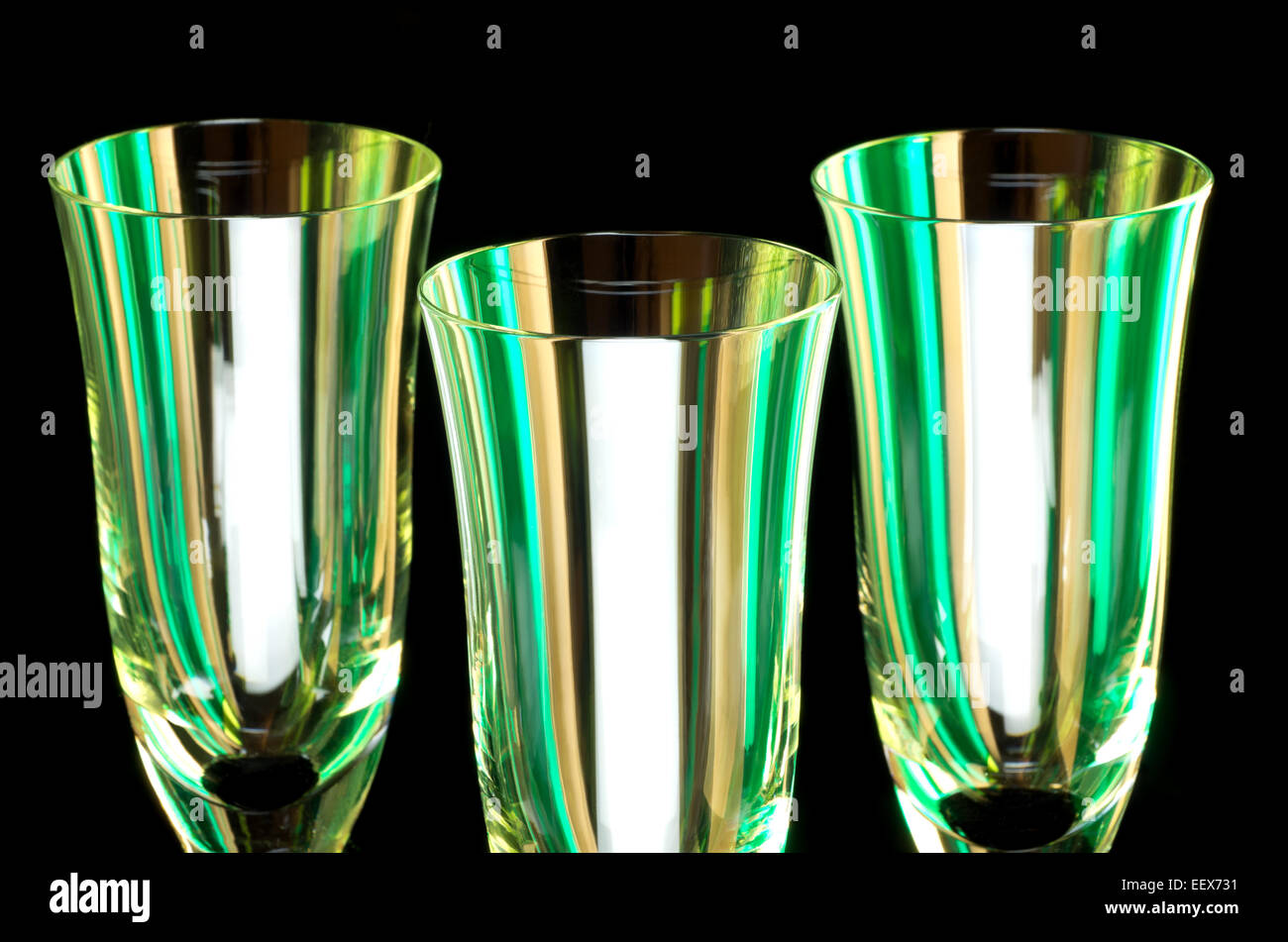 Abstract of flute glasses or champagne stemware side by side and closeup isolated against black Stock Photo