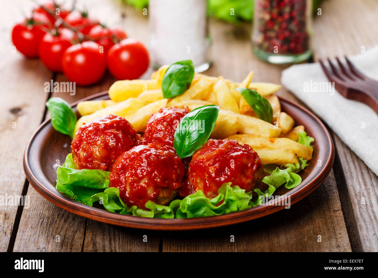 meatballs in tomato sauce with french fries Stock Photo