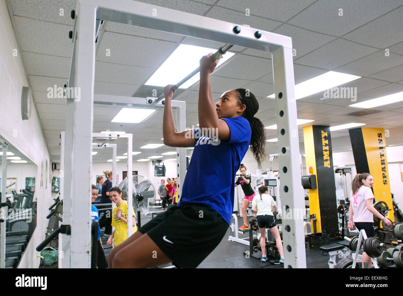 Sprinter/Long Jumper Zoie Reed does pull-ups in the weight room at Amity High. Amity does not have an indoor track so track and field members must get creative in their off season training. CT USA Stock Photo