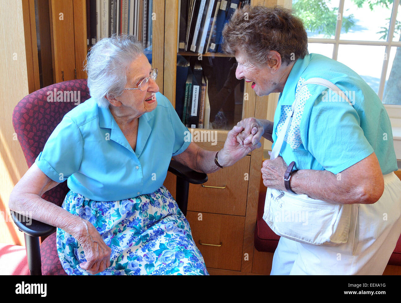 Guilford CT USA Edith Nettleton greets Doris Bedel, 92, during her 105th birthday party at the Guilford Library, where she still volunteers. Bedel is from Guilford. Stock Photo