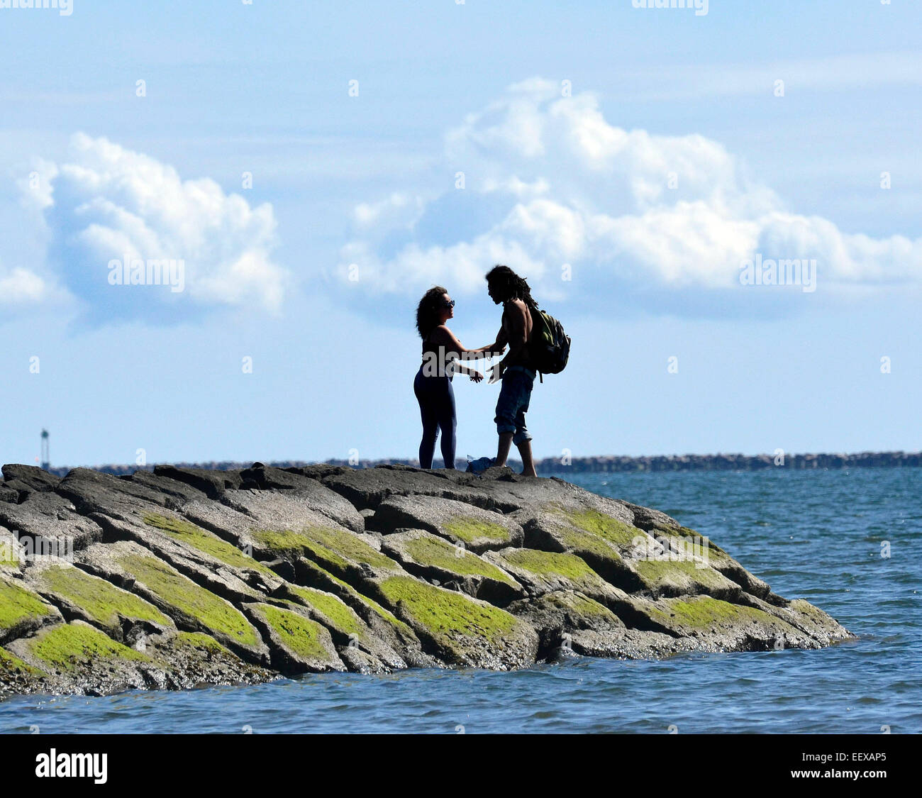 West Haven CT USA Armando Ortiz and Alisha Braacker enjoy the weather on the jetty near Savin Rock in West Haven. Ortiz is from San Juan, Puerto Rico, and Braacker is from West Haven. Stock Photo