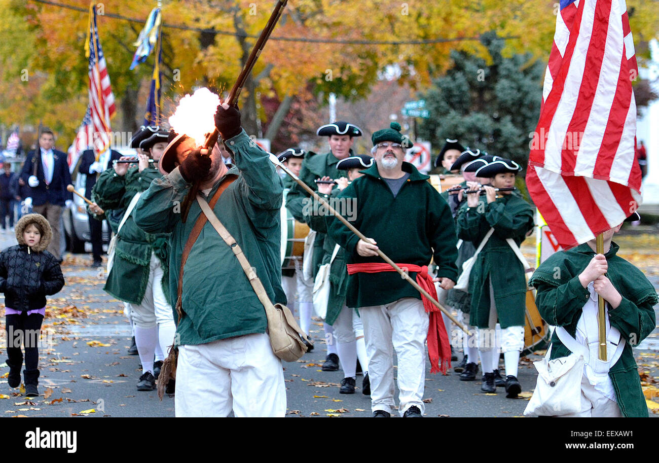 Milford, CT USA  Mark Deer of the Milford Volunteers shoots a musket during the Milford Veterans Day Parade. Stock Photo