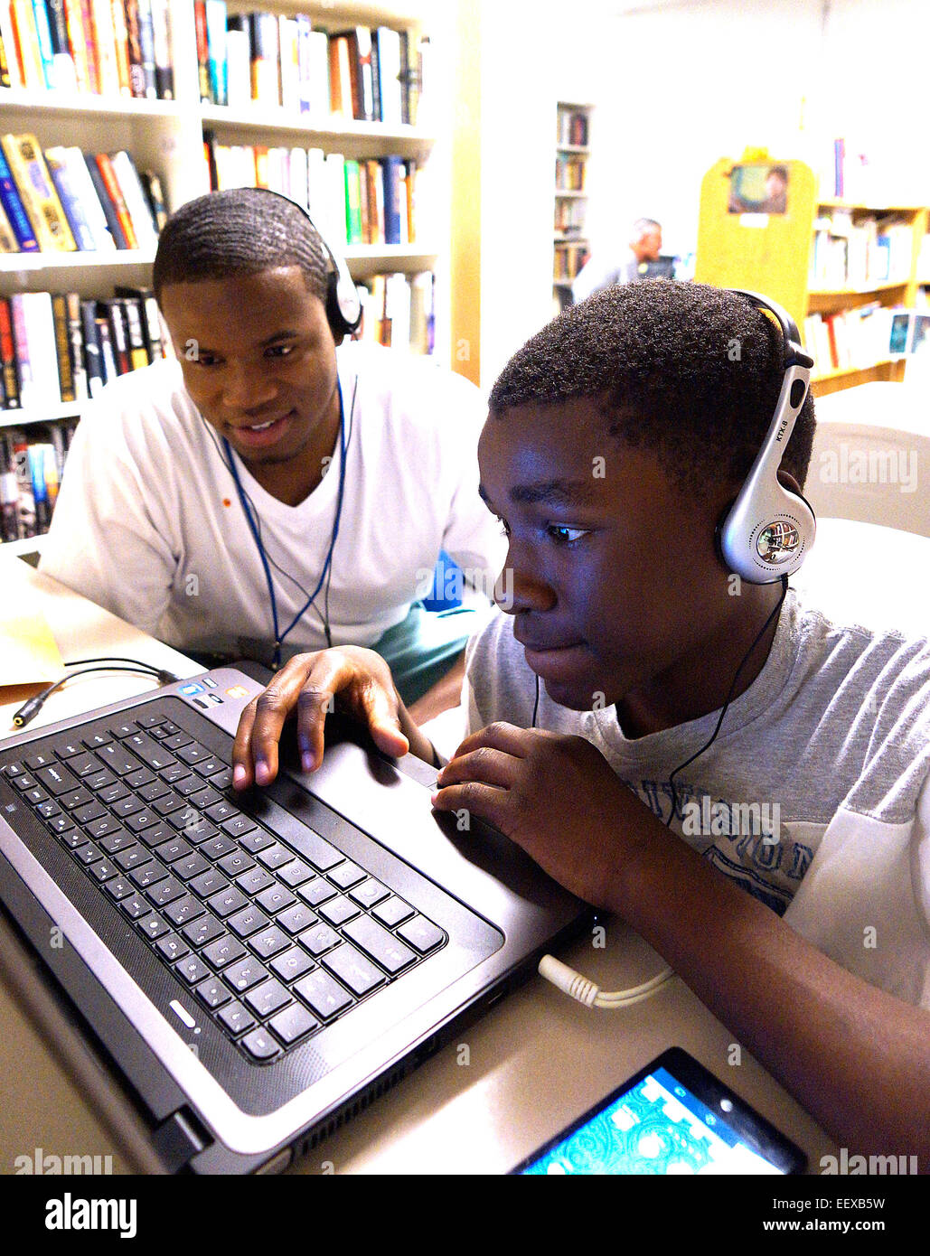 School mentoring program--Darryl Lyons, an Albertus Magnus Jr., works with Demetrius Daniley, a 7th grader from Jackie Robinson School at the New Haven Reads center. Lyons is an intern for the summer with funds from a grant from First Niagara Bank. Stock Photo