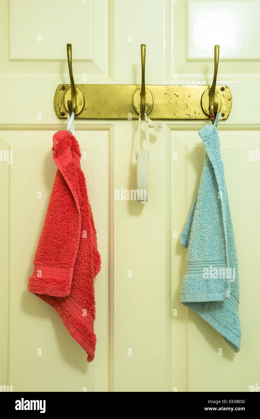 Two towels hanging on a bathroom door Stock Photo