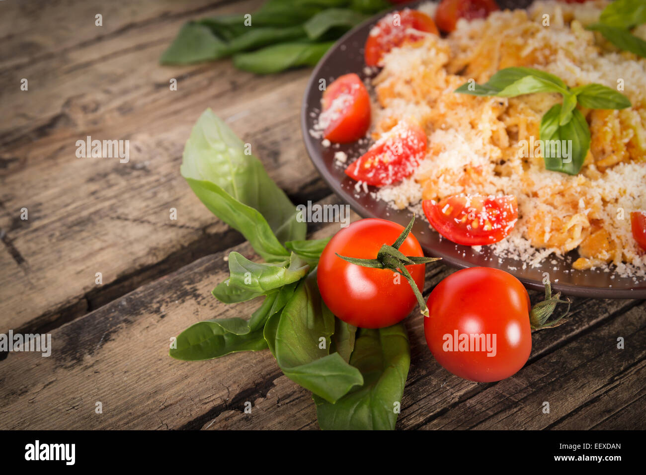 Tasty fresh Pasta with chicken on a wooden background Stock Photo