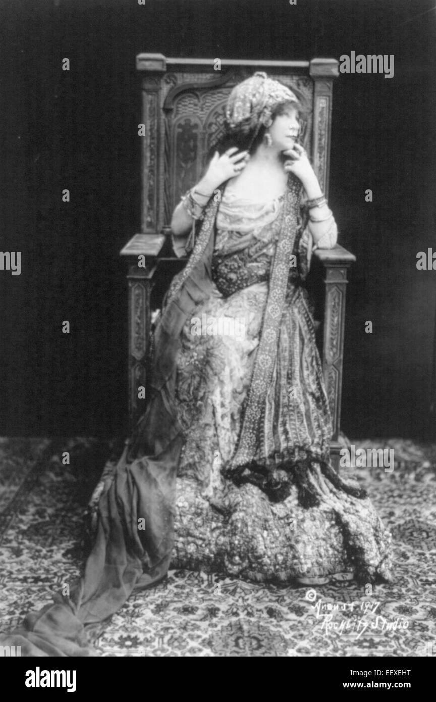 Sarah Bernhardt, full length portrait, seated in throne-like chair; in elaborate costume, circa 1917 Stock Photo