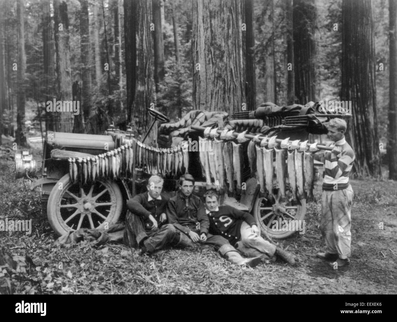 A Day's Catch at Big Lagoon - 4 young men with a large catch of trout, which are displayed in front of automobile, 1908. Stock Photo