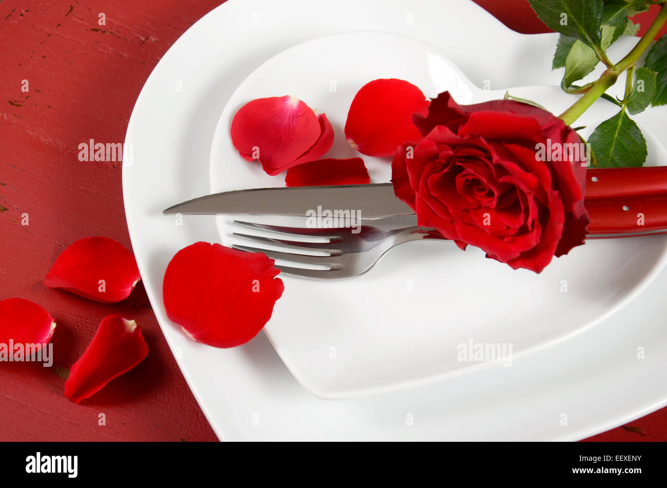 Romantic Valentines Day table place setting with white heart shape ...