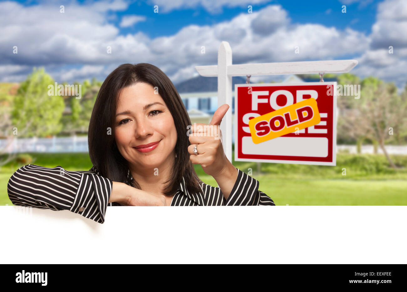 Pretty Hispanic Woman Leaning on White with Thumbs Up in Front of ...