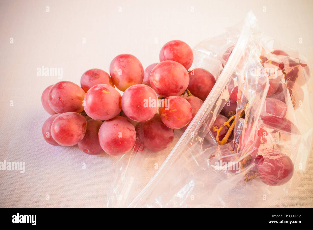 Grapes in a plastic bag on a white background Stock Photo Alamy