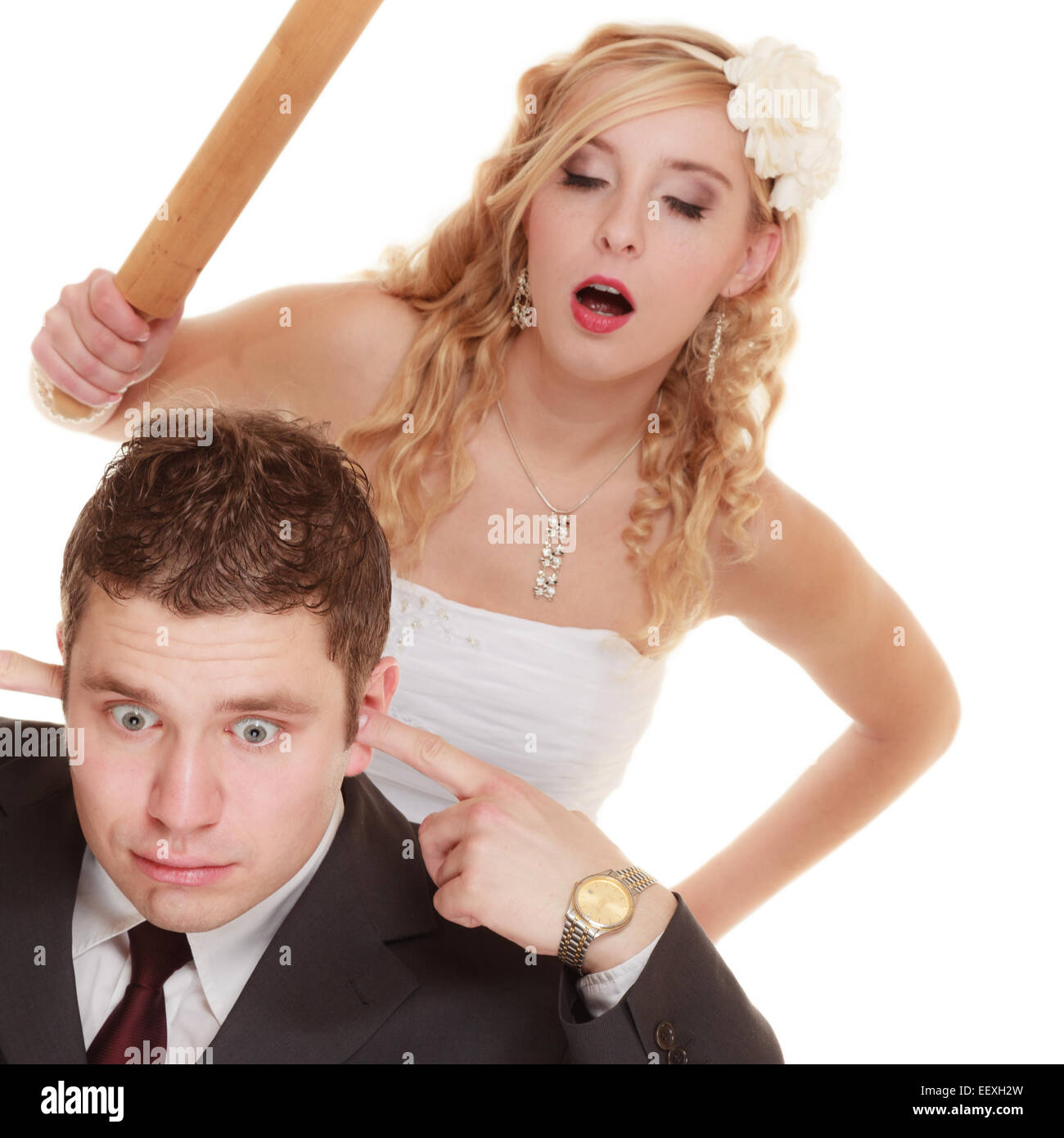Wedding couple having argument - conflict, bad relationships. Angry woman fury bride holds rolling pin in fight with groom. Isol Stock Photo