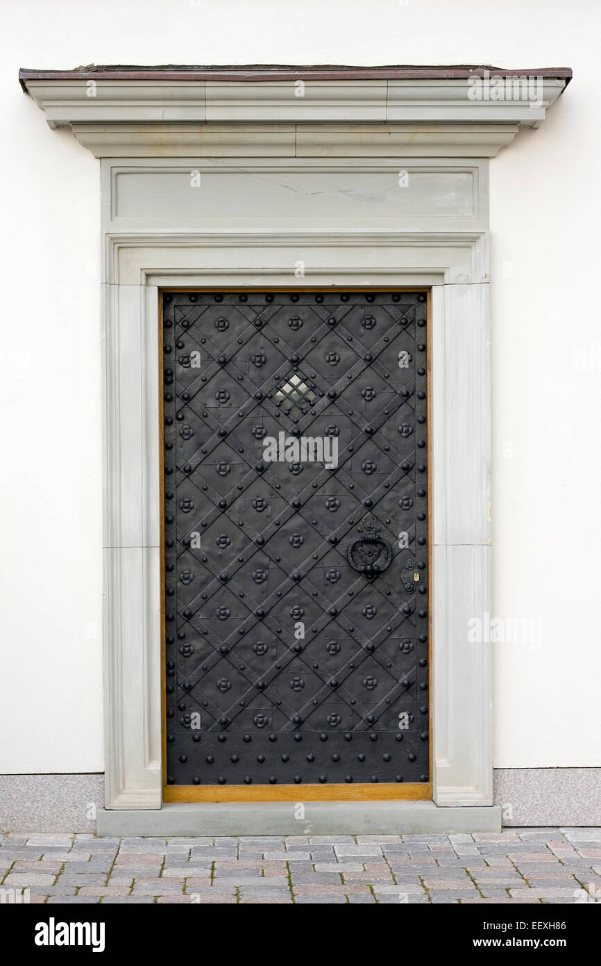 Modern iron door in a retro medieval style. mass production Stock Photo ...