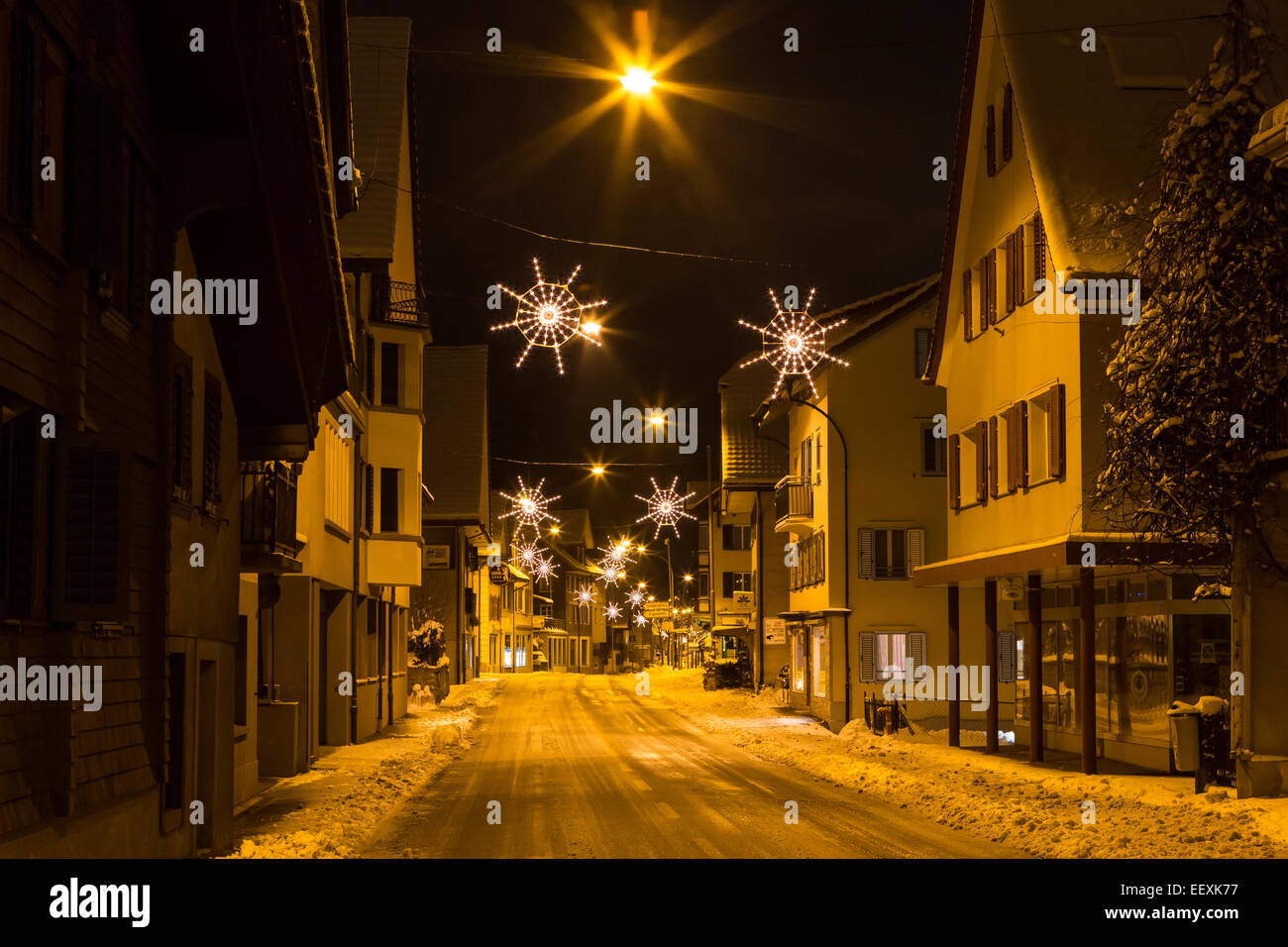 Snowy street with Christmas lights, Malters, Lucerne, Switzerland Stock Photo