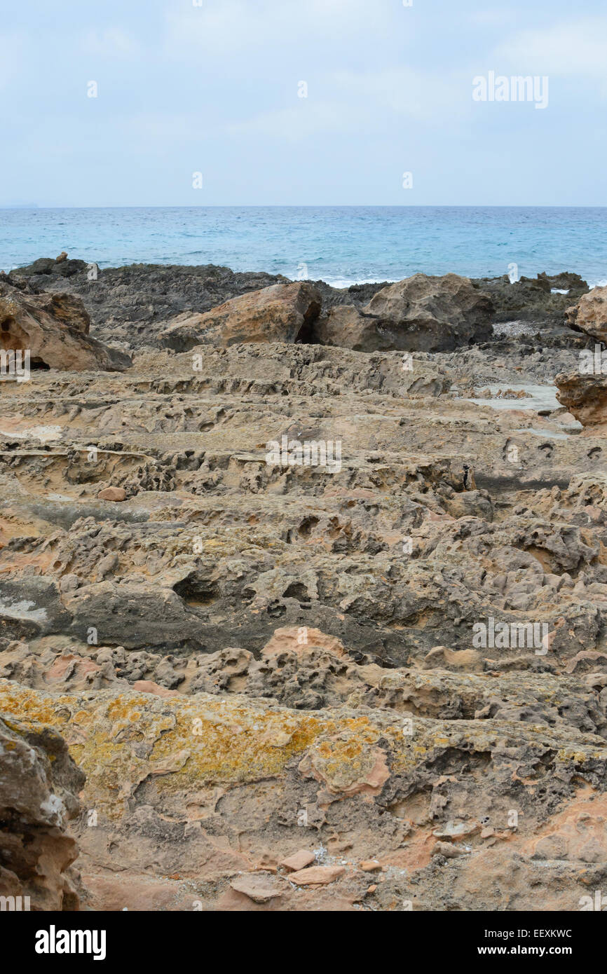 A challenge for the feet - the ground is strongly eroded limestone rock with cavities, grooves and sharp ribs. Stock Photo