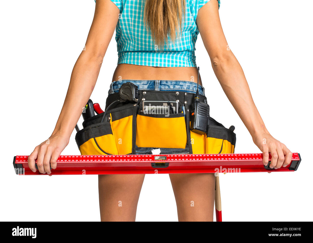 Woman wearing tool belt with tools holding builders level, close up