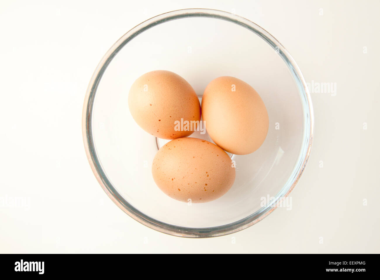 Three Brown Free Range Eggs in a Glass Bowl Stock Photo