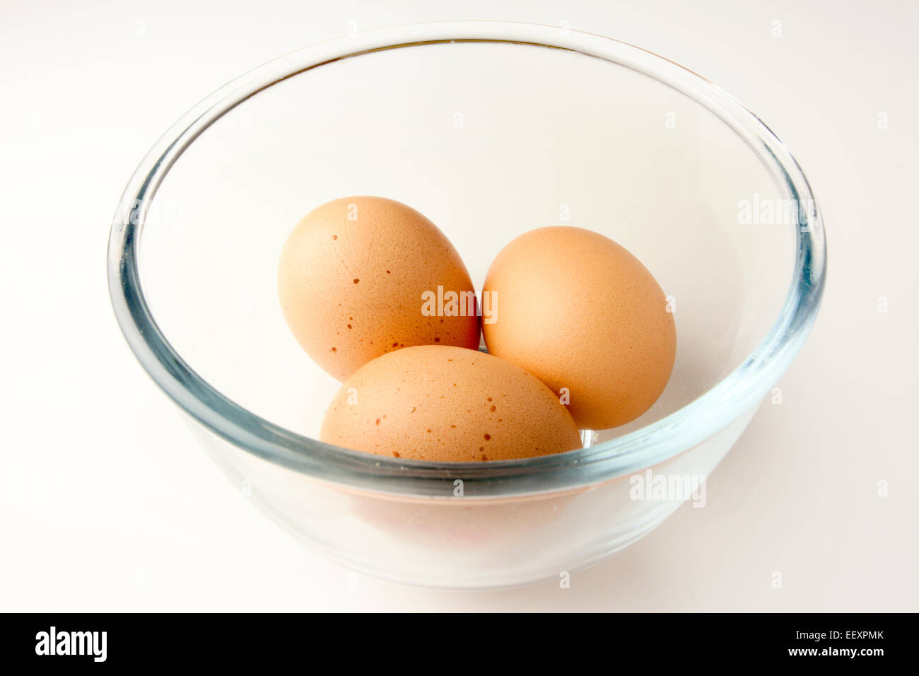 Three Brown Free Range Eggs in a Glass Bowl Stock Photo