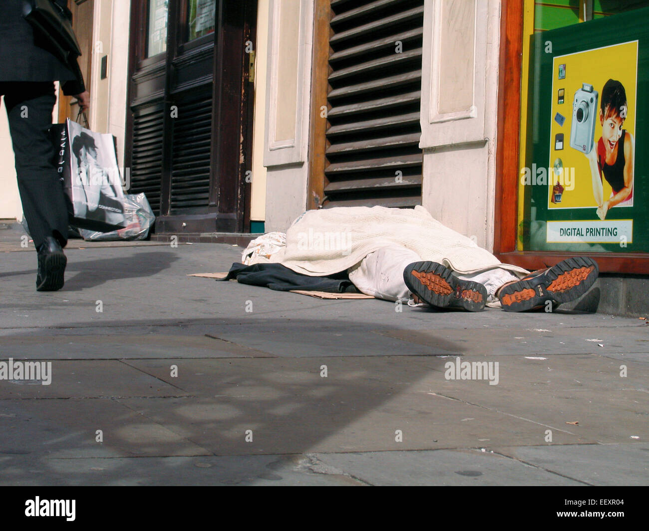Sleeping rough Homeless destitute tramp asleep on street near The Strand London UK  Central London Stock Photo