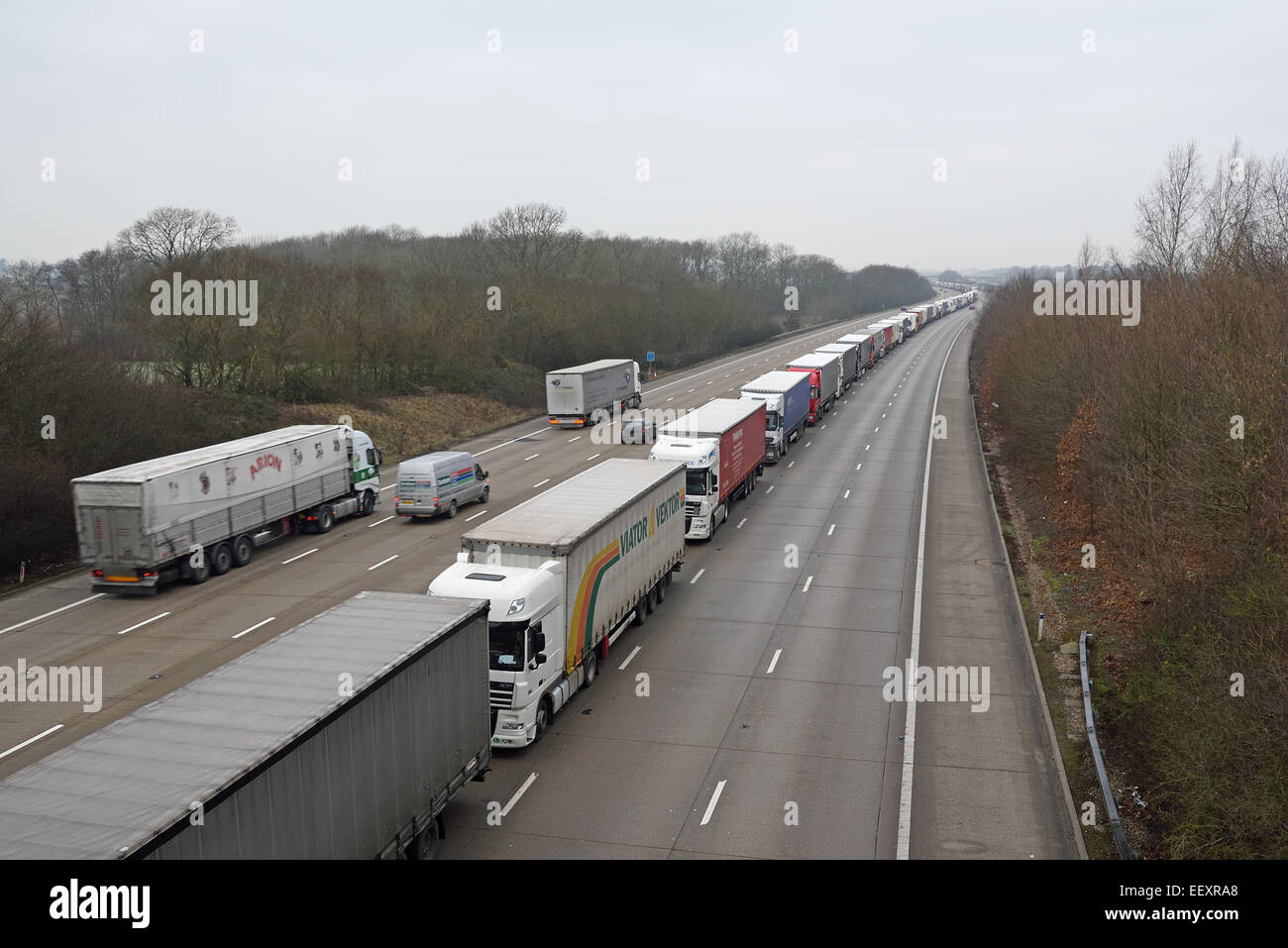 Ashford, Kent, UK. 23rd Jan, 2015. Phase 2 of Operation Stack continues today owing to delays in the Channel Tunnel.  The Operation involves freight vehicles being stacked on the coastbound M20 motorway between Junctions 8 and 9 pending police permission to proceed.  Other traffic travelling towards the coast is routed via the A20 whilst the London bound carriageway is currently unaffected. Severe delays are reported and the Operation is set to continue through the weekend. Credit:  Paul Martin/Alamy Live News Stock Photo