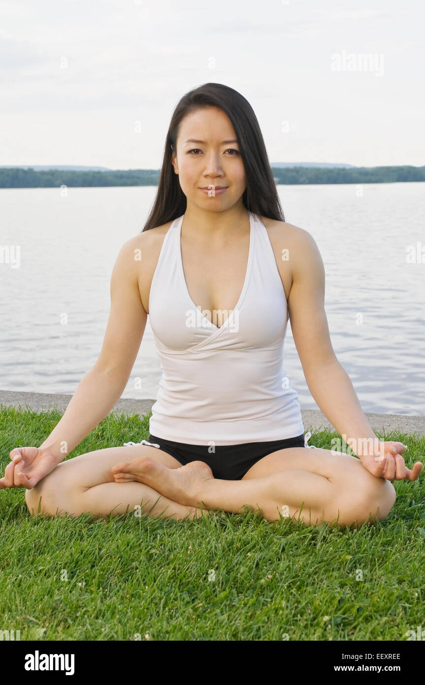 Focused asian woman doing yoga hi-res stock photography and images - Alamy
