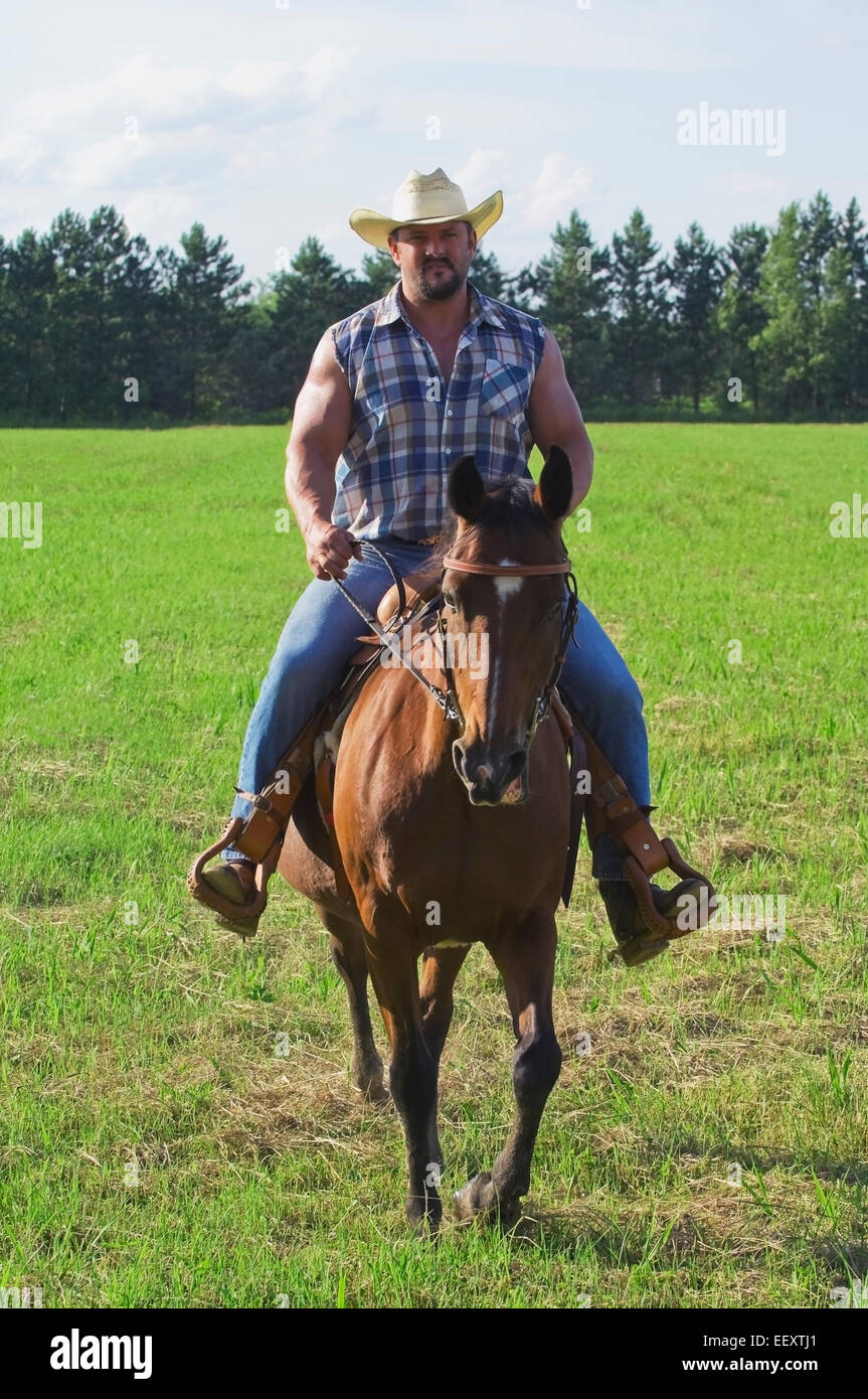 Man riding a horse outdoors Stock Photo