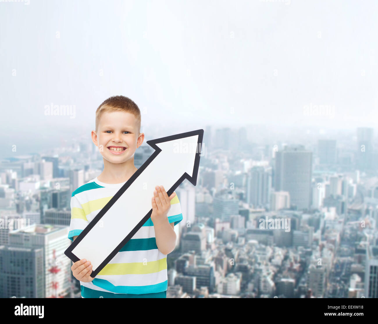 smiling little boy with blank arrow pointing right Stock Photo