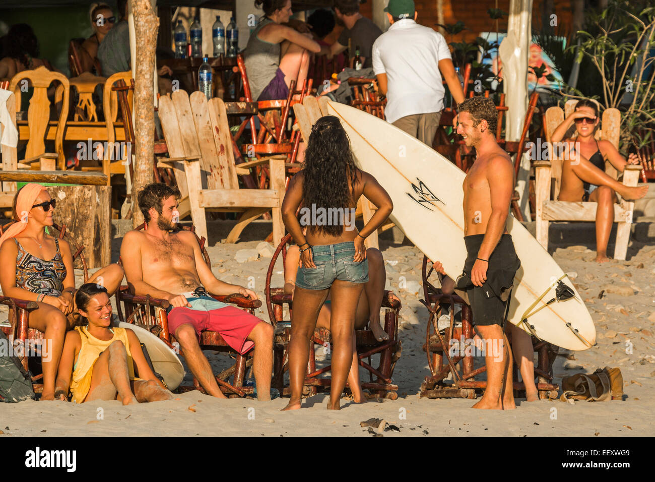 People & bar at sunset on this surf beach near tourist hub San Juan del Sur; Playa Maderas, San Juan del Sur, Rivas, Nicaragua Stock Photo
