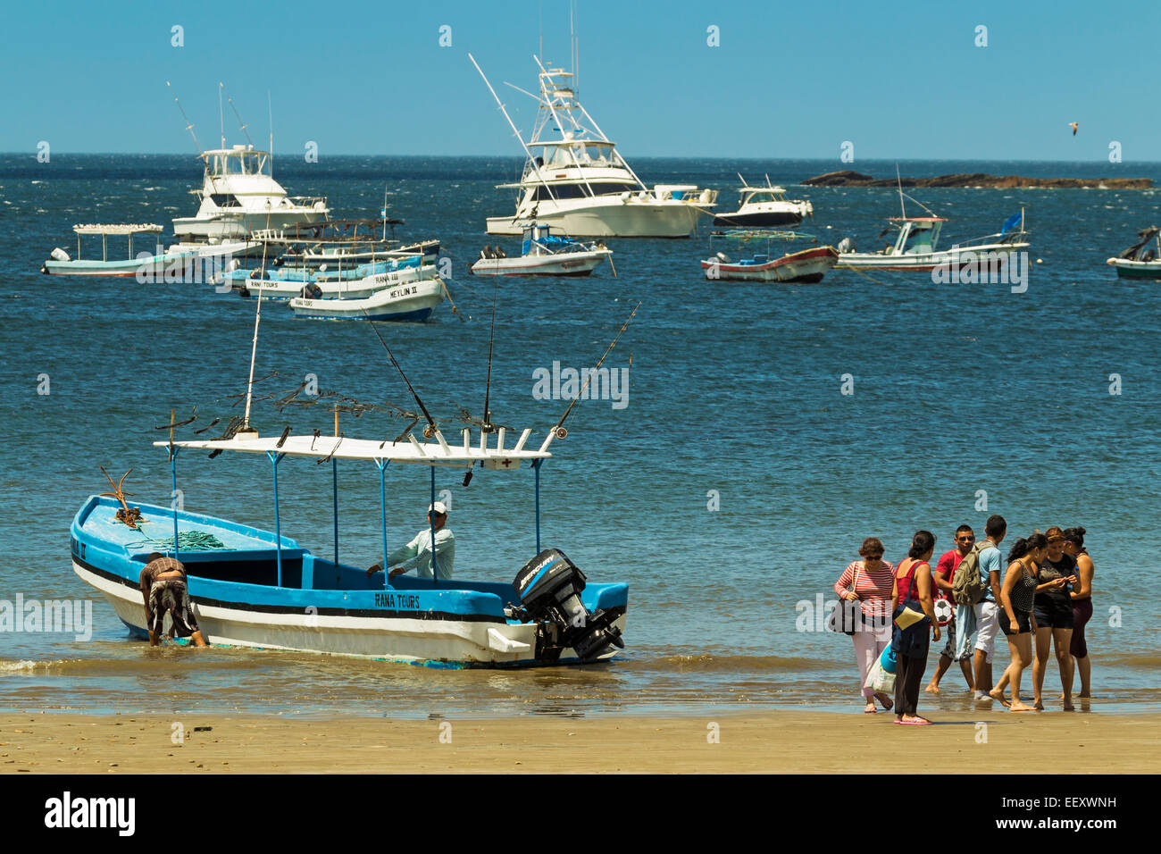 Tour boat on town beach of this popular tourist hub for the southern surf beaches; San Juan del Sur, Rivas Province, Nicaragua Stock Photo