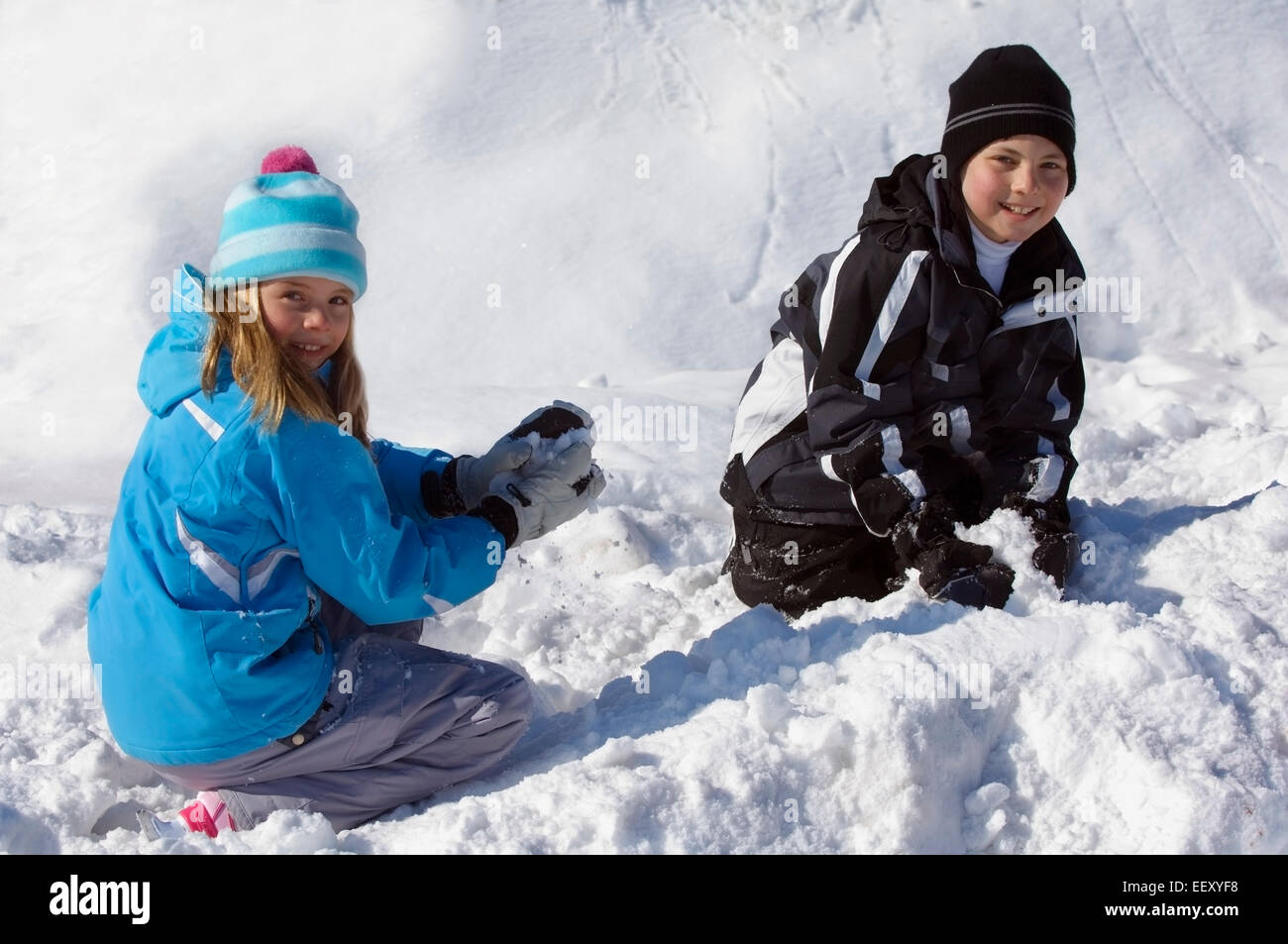 Brother and sister playing outdoors in winter Stock Photo - Alamy