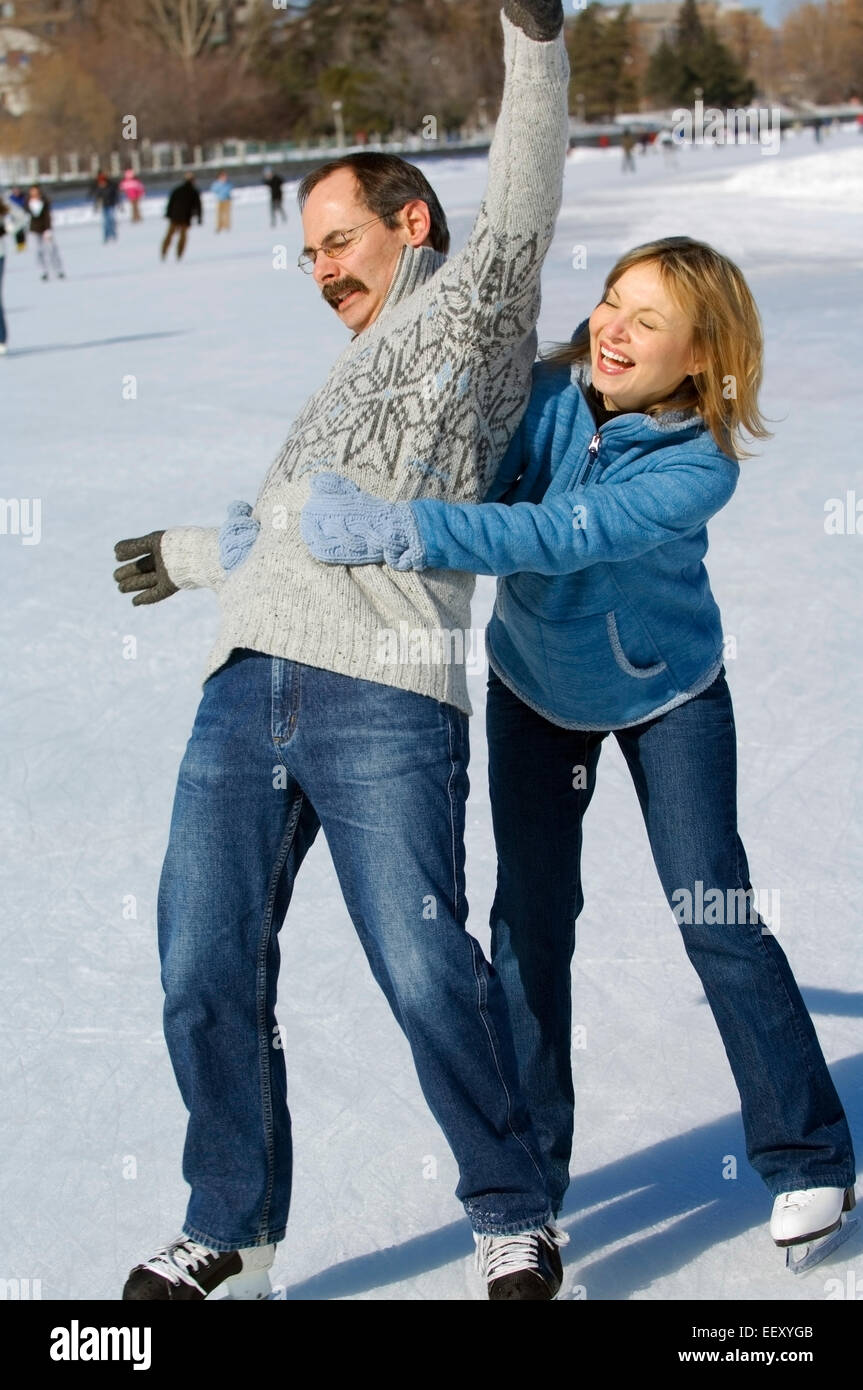 Couple ice skating outdoors together Stock Photo Alamy