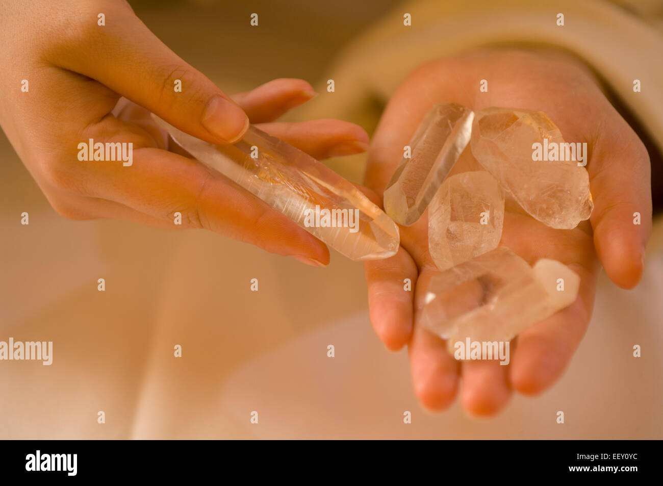 Young woman holding crystals in hands Stock Photo