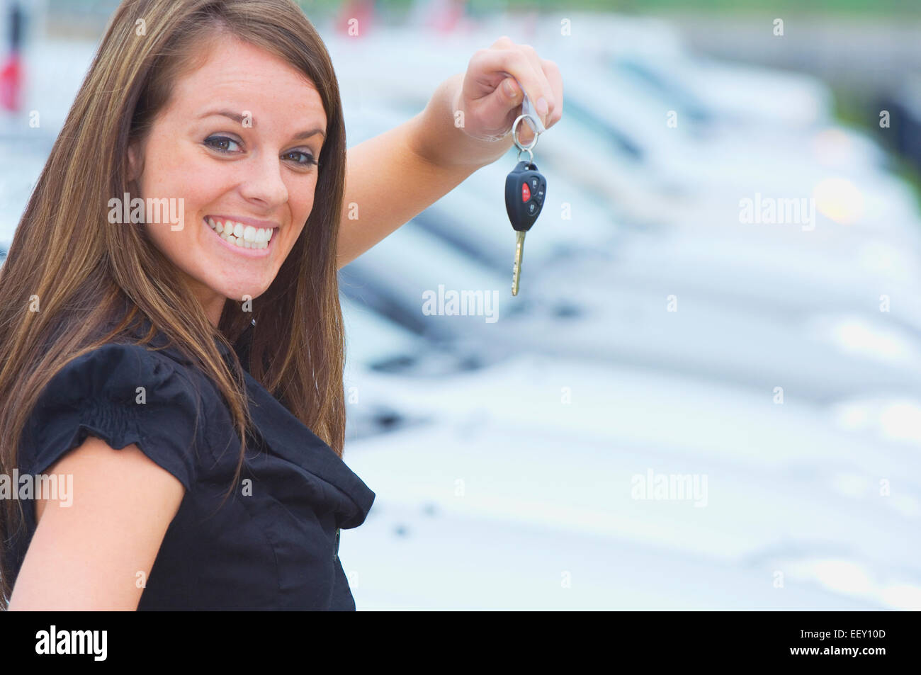 Woman outside at a car dealership Stock Photo Alamy