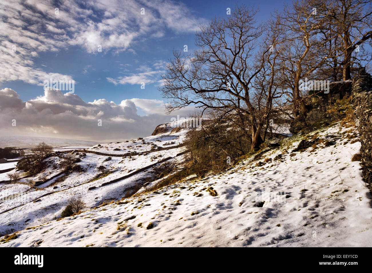 Snow on the Norber plateau, overlooking the village of Austwick, Yorkshire Dales National Park, UK Stock Photo