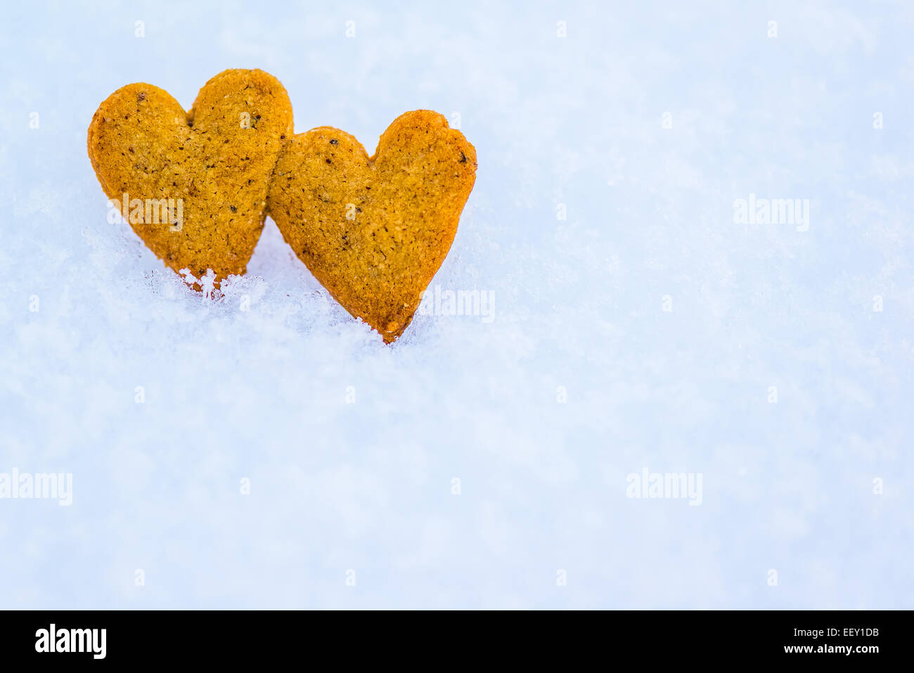 Gingerbread hearts on snow Stock Photo