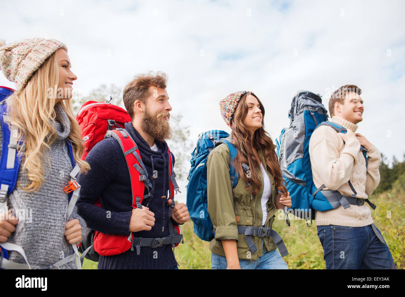 group of smiling friends with backpacks hiking Stock Photo - Alamy
