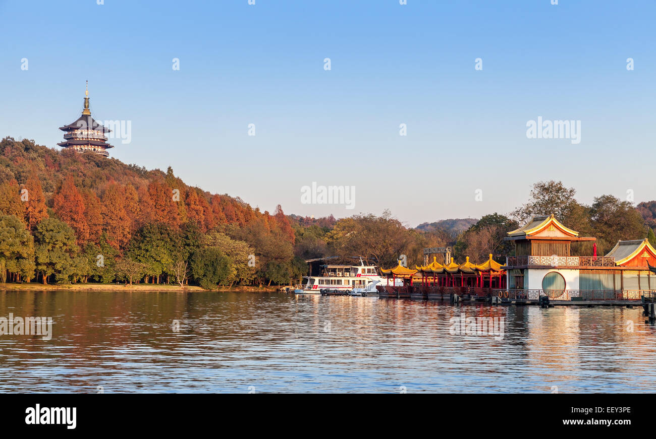 Hangzhou, China - December 5, 2014: Chinese wooden recreation boats and pagoda on the coast of West Lake. Famous park in Hangzho Stock Photo